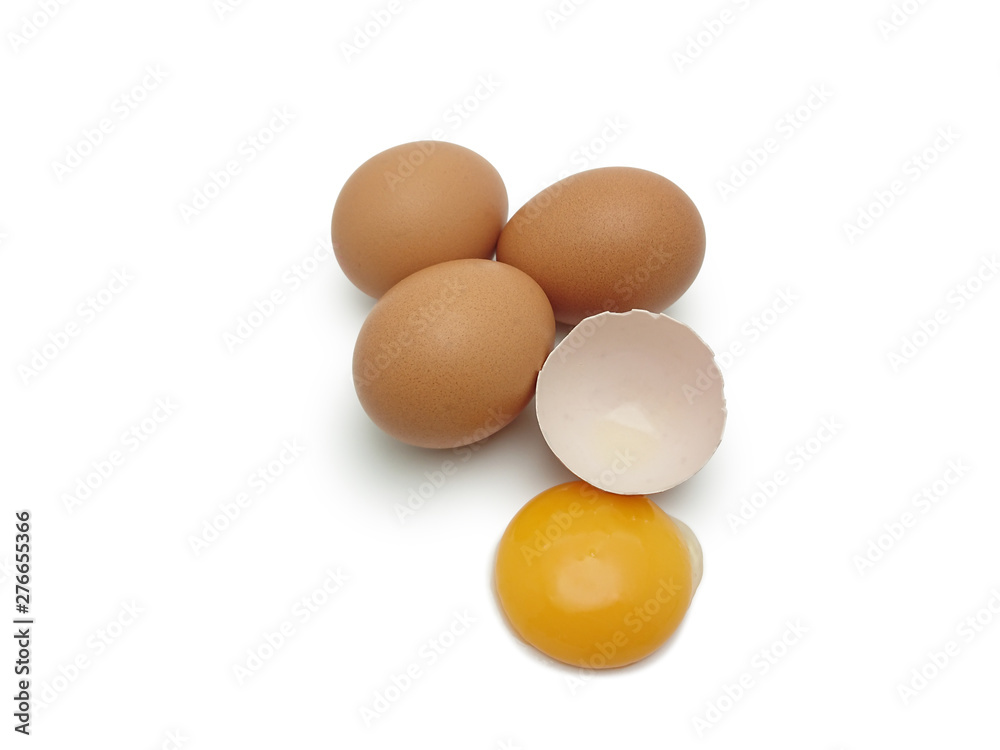 Whole eggs with cracked egg showing yolk isolated on white background