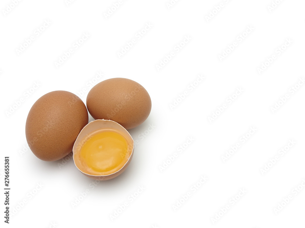 Whole eggs with cracked egg showing yolk isolated on white background