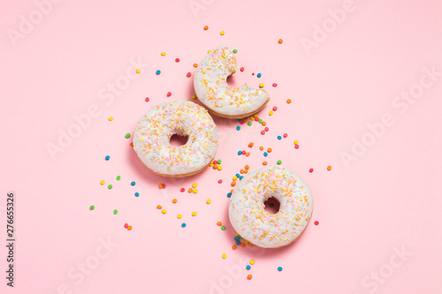 Fresh tasty sweet donuts on a pink background. Bakery concept, fresh pastries, delicious breakfast, fast food, coffee shop. Flat lay, top view