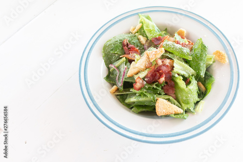 Closeup of healthy Caesar salad with croutons and Ham sliced