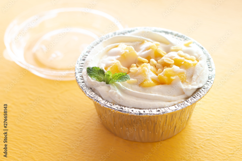 Summer fruit dessert is Mango cheesecake on yellow table background