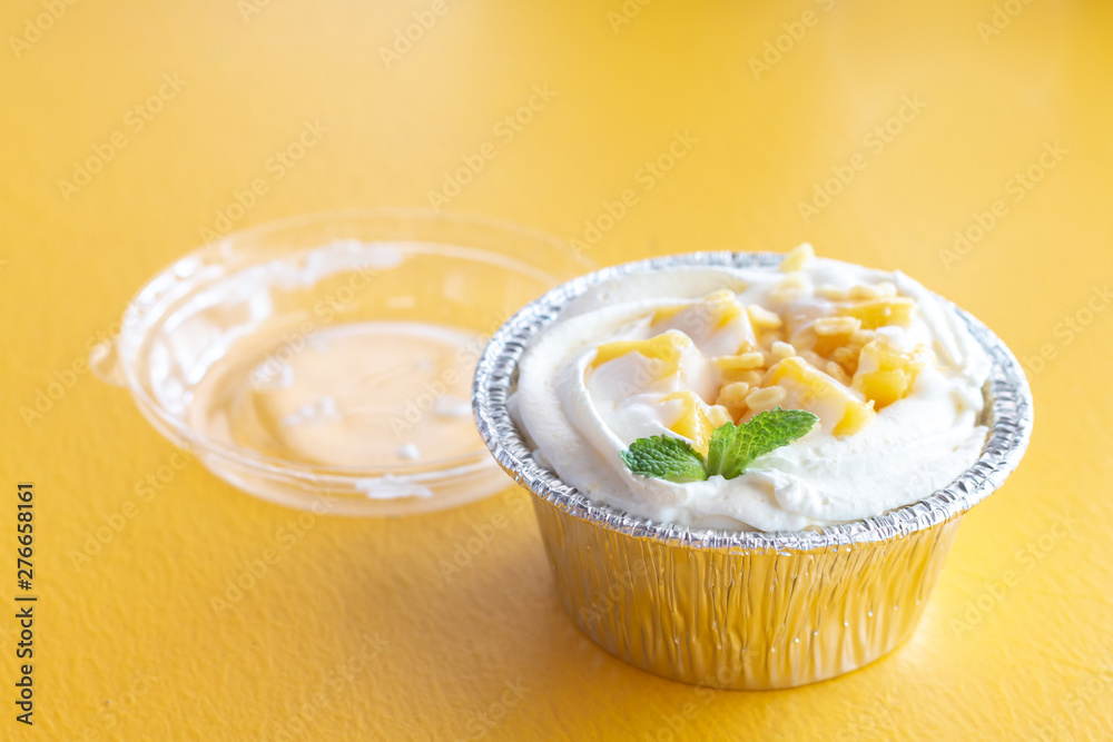 Summer fruit dessert is Mango cheesecake on yellow table background Summer fruit dessert is Mango cheesecake on yellow table background