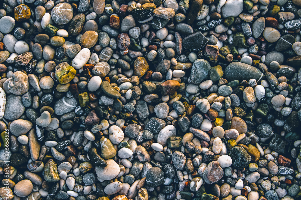 Beach stone pebbles. The texture of small stones and sand. Can be used as a texture, background or wallpaper Beach stone pebbles. The texture of small stones and sand. Can be used as a texture, background or wallpaper