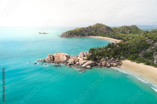 Beach aerial with palm trees, blue turquoise ocean and white sand. Magazine cover for travel, lifestyle, fashion photo