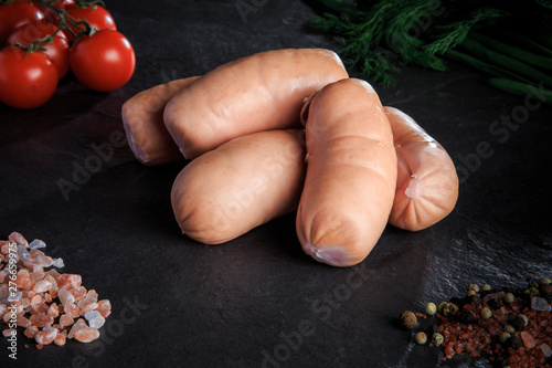 closeup set of thick short sausages with dill and tomatoes