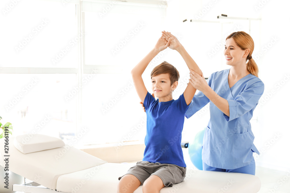 Fototapeta premium Physiotherapist working with little boy in rehabilitation center