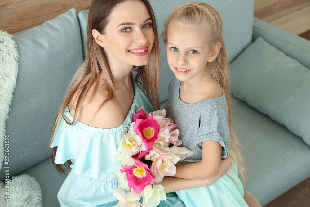 Little girl greeting her mother with bouquet of tulips at home Little girl greeting her mother with bouquet of tulips at home