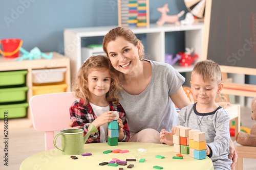 Nursery teacher with cute l...