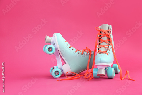 Vintage roller skates on color background photo