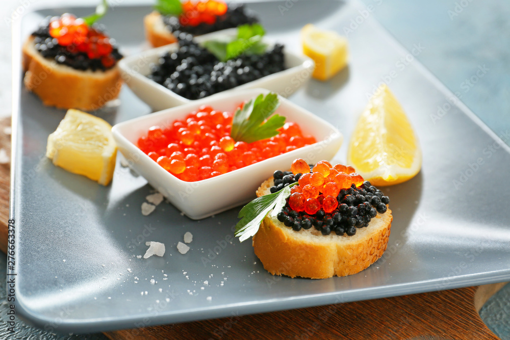 Black and red caviar on plate, closeup Black and red caviar on plate, closeup
