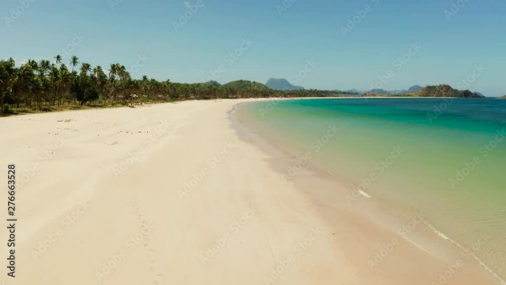 Aerial drone of Seascape with sandy beach and blue water. Seascape with sea, sand, palm trees. Nacpan, El Nido, Palawan, Philippines. Summer and travel vacation concept Aerial drone of Seascape with sandy beach and blue water. Seascape with sea, sand, palm trees. Nacpan, El Nido, Palawan, Philippines. Summer and travel vacation concept