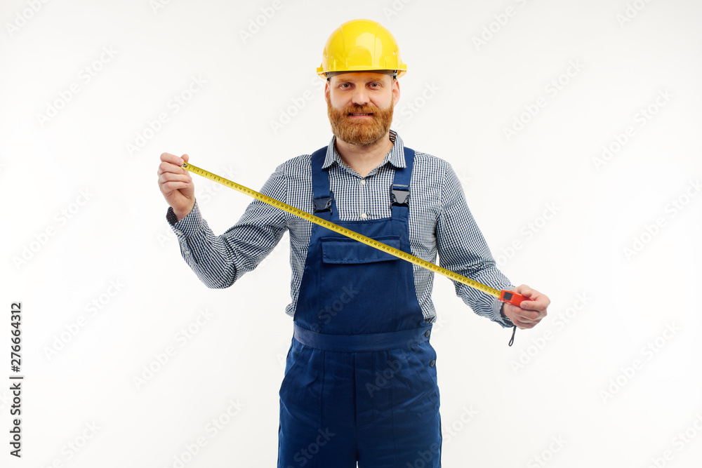 Engineer holding a construction tape measure on a white background. Engineer holding a construction tape measure on a white background.