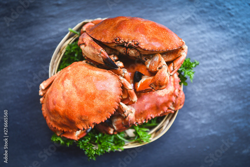 Cooked crab on steamer and dark background - Seafood boiled red stone crabs