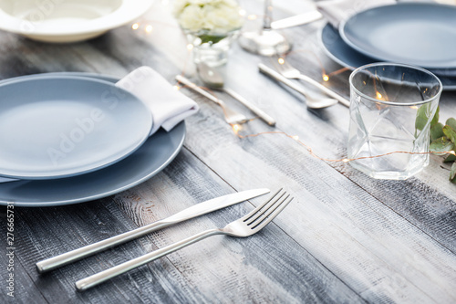 Beautiful table setting on wooden background photo