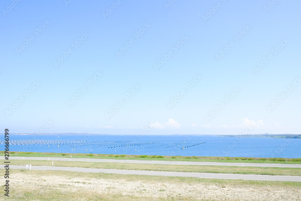 Beautiful Beach With Crystal Clear Blue Waters of The Sea Against Blue Sky on a summers day Beautiful Beach With Crystal Clear Blue Waters of The Sea Against Blue Sky on a summers day