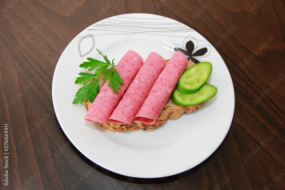 sandwich of rye bread with meat sausage, cucumbers and parsley sandwich of rye bread with meat sausage, cucumbers and parsley