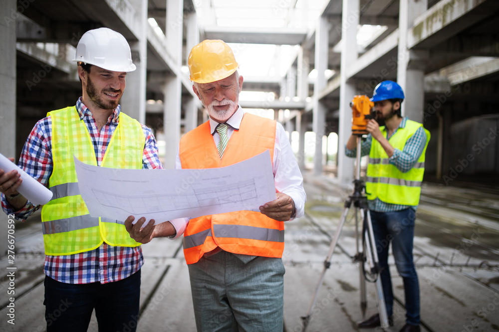 Engineer, foreman and worker discussing in building construction site Engineer, foreman and worker discussing in building construction site
