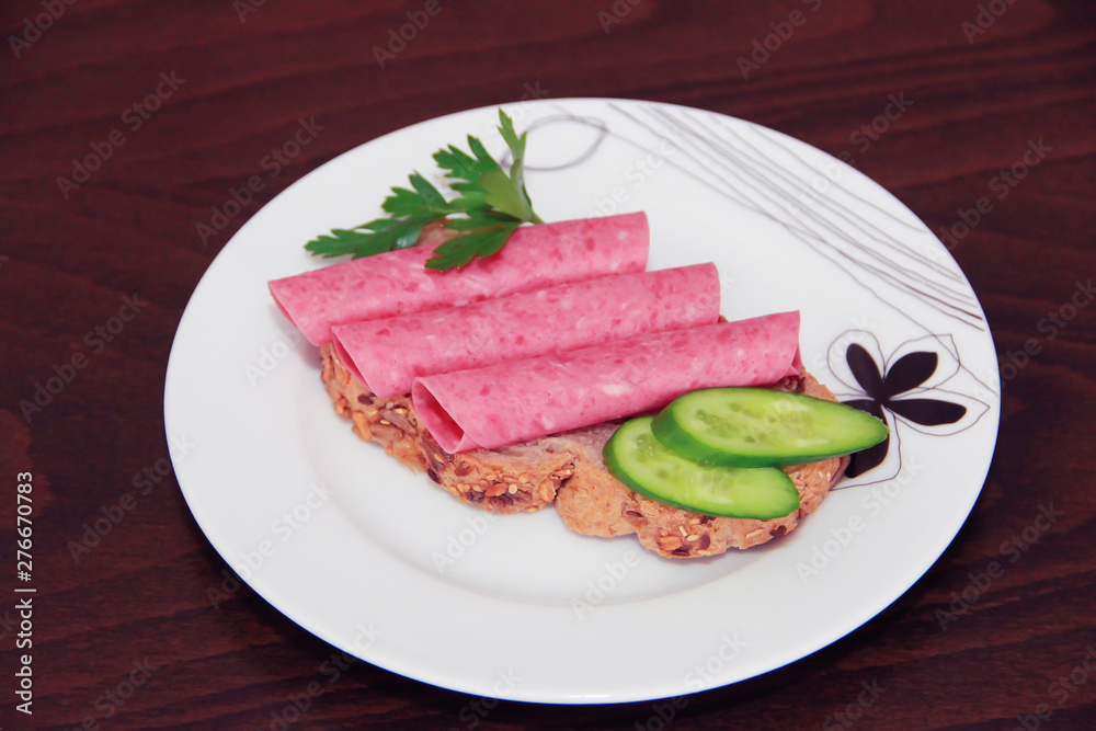 sandwich of rye bread with meat sausage, cucumbers and parsley sandwich of rye bread with meat sausage, cucumbers and parsley