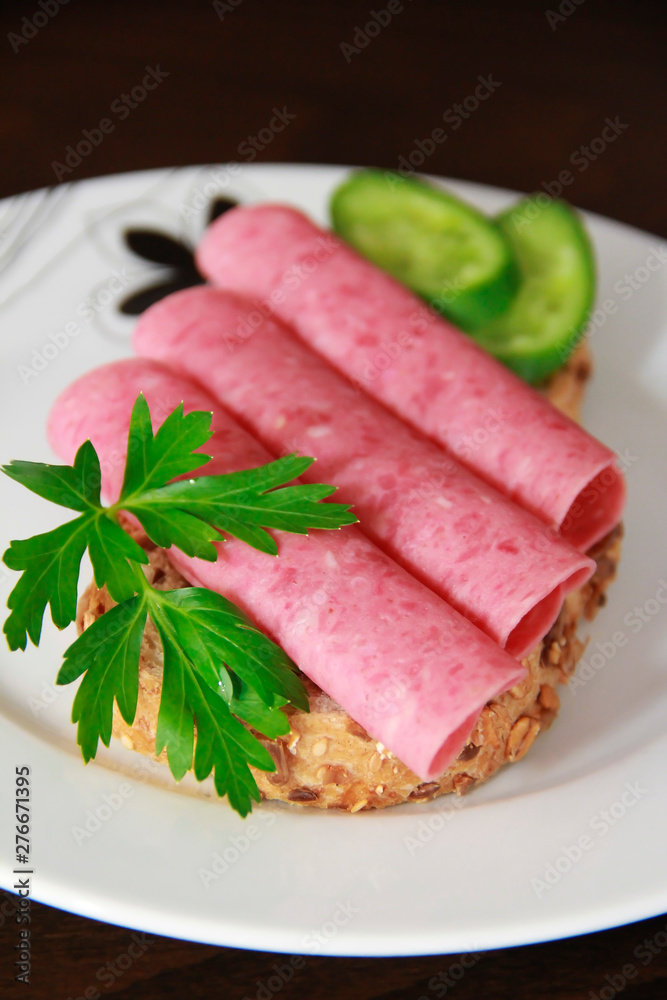 sandwich of rye bread with meat sausage, cucumbers and parsley sandwich of rye bread with meat sausage, cucumbers and parsley