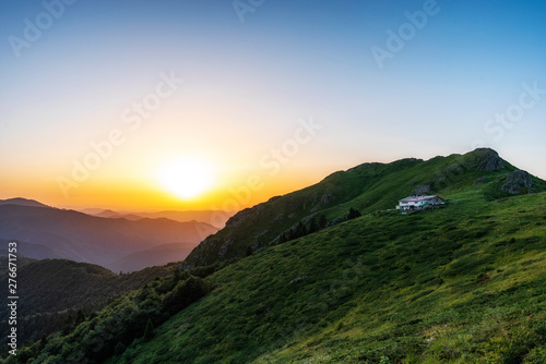 Beautiful clear sky summer sunset in the mountains. Landscape with sun light shining