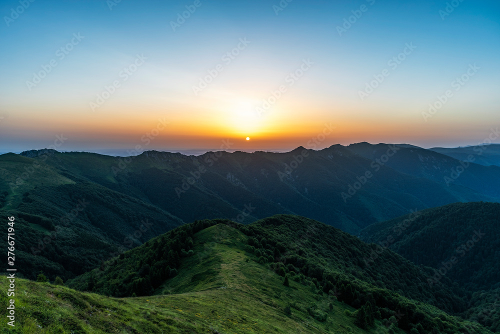 Fototapeta premium Mountain valley during sunrise. Natural summer landscape