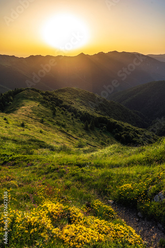 Beautiful clear sky summer sunset in the mountains. Landscape with sun light shining © Petar