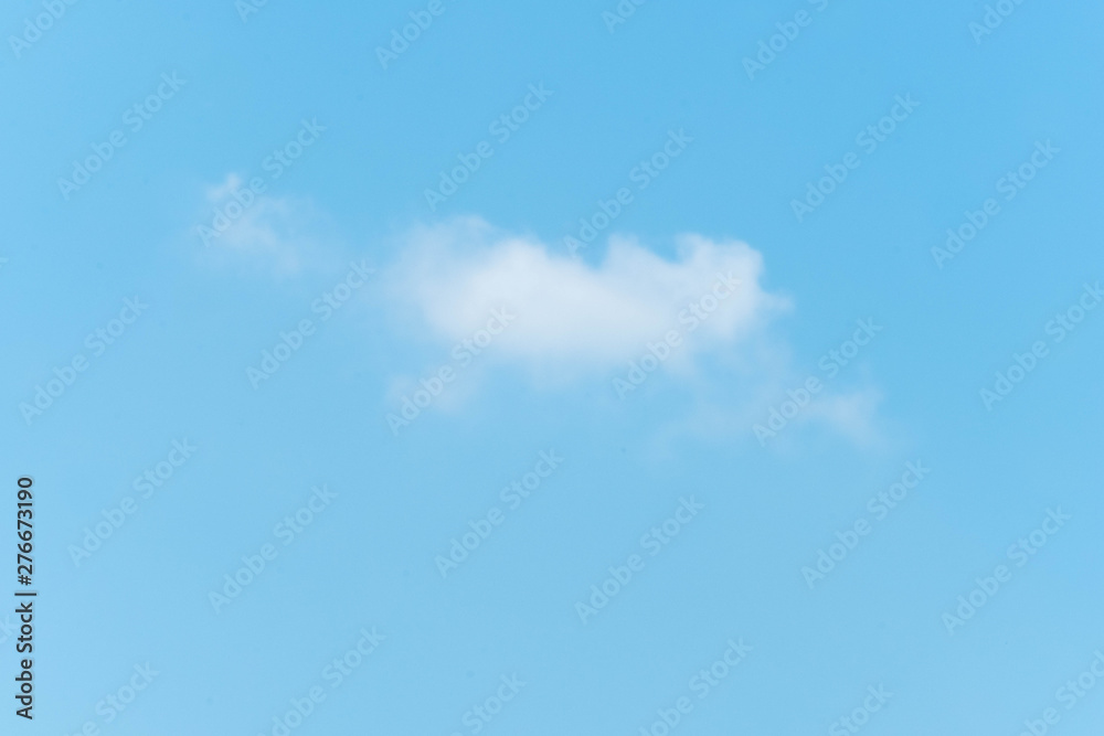 Some small white clouds floating in the blue sky Some small white clouds floating in the blue sky