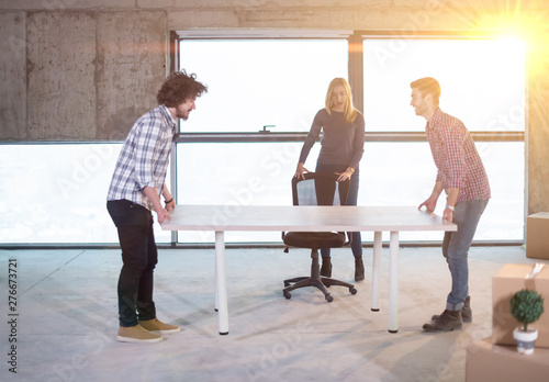 business team carrying white table
