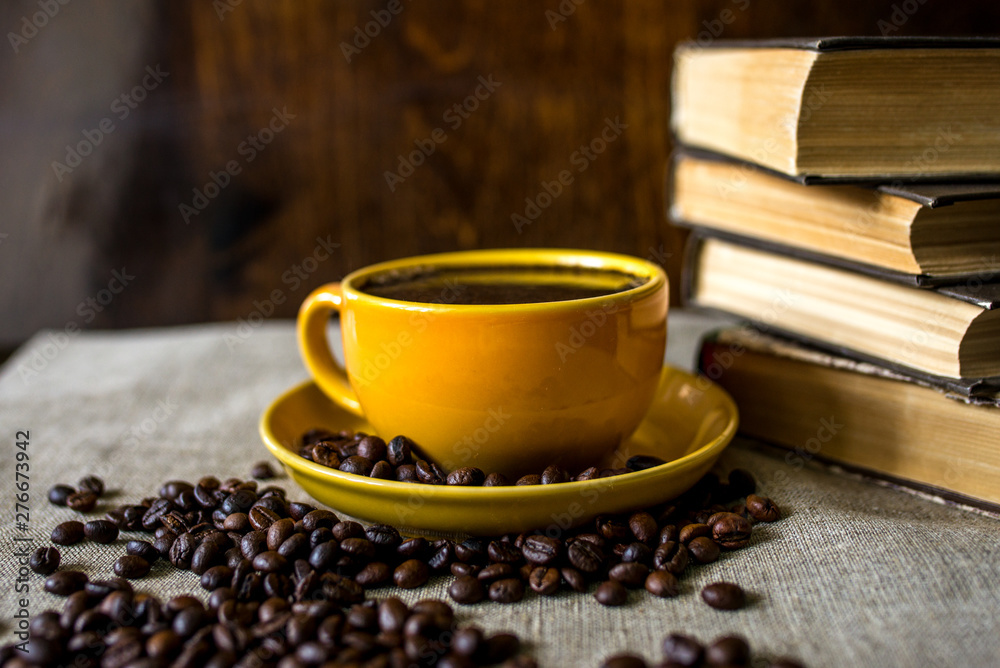 cup of coffee and beans on wooden table cup of coffee and beans on wooden table