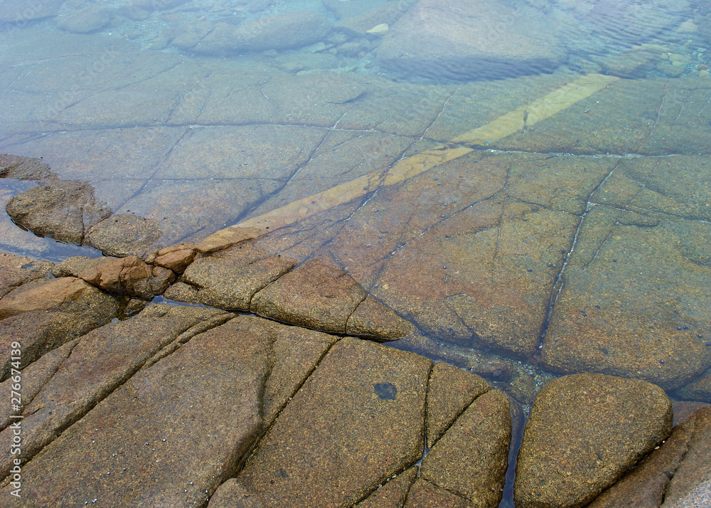 Lines, cracks and fissures form patterns on bottom in shallow sea ...