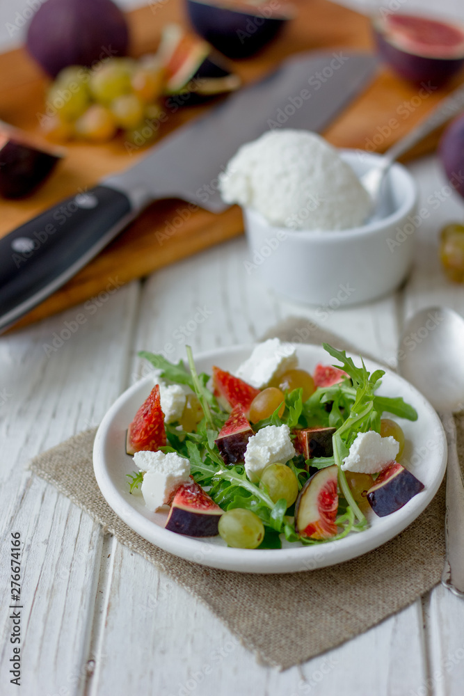 Salad with goat chees, arugula and figs. Salad with goat chees, arugula and figs.