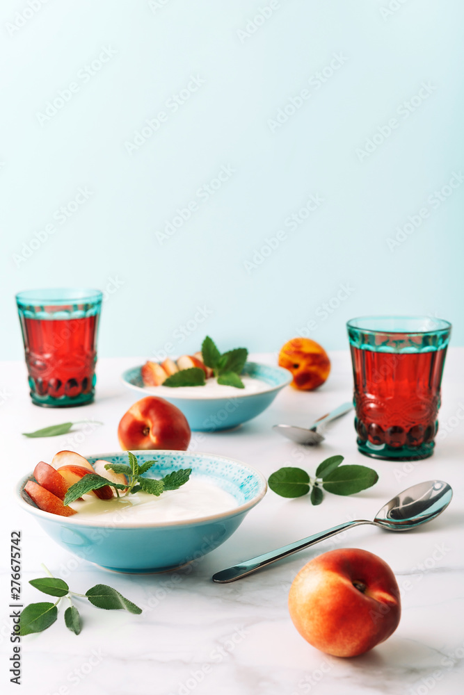 Healthy breakfast of natural greek yoghurt, nectarines and juice on marble table. Close-up. Healthy breakfast of natural greek yoghurt, nectarines and juice on marble table. Close-up.