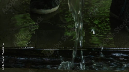 MEN'S HANDS WITH WATCHES AND BRACELET GET WATER FROM THE SPRING slowly close up