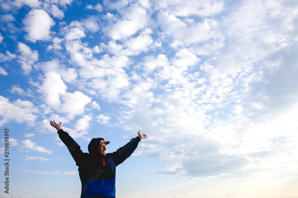 Happy man raised wide open arms traveling hiker blue sky and clouds healthy lifestyle adventure vacations outdoor success joyful emotions freedom Happy man raised wide open arms traveling hiker blue sky and clouds healthy lifestyle adventure vacations outdoor success joyful emotions freedom