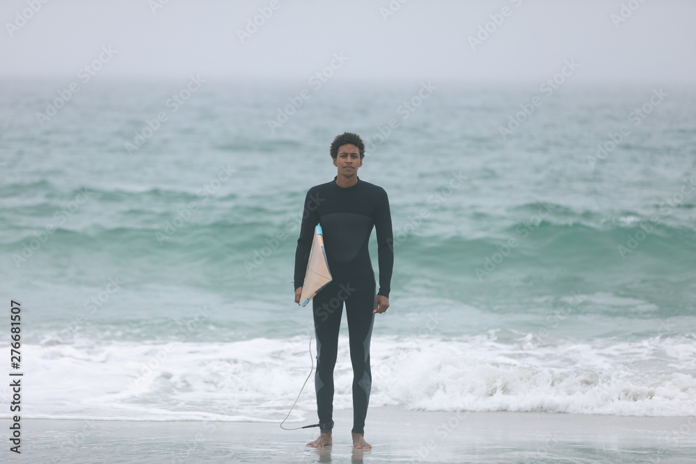 Male surfer running on the beach with surfboard Male surfer running on the beach with surfboard