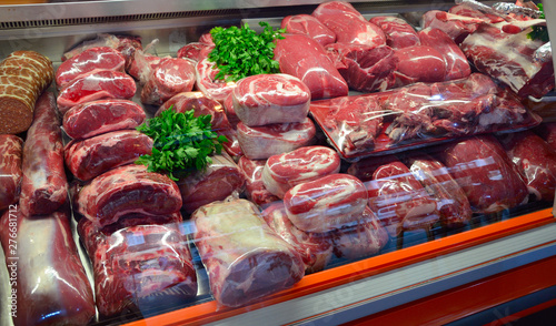 Quadro su tela Showcase with raw meat in butcher shop.