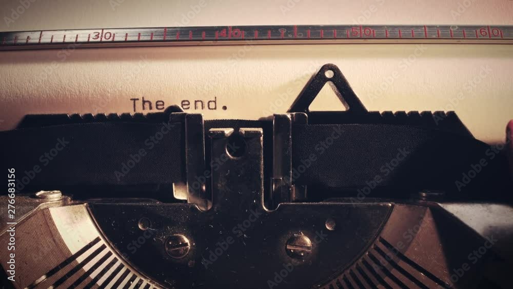 The word The End' being typed on a vintage old typewriter