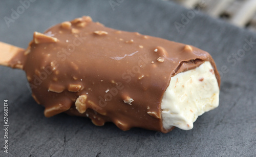 Vanilla milk chocolate almond bar ice cream on black background