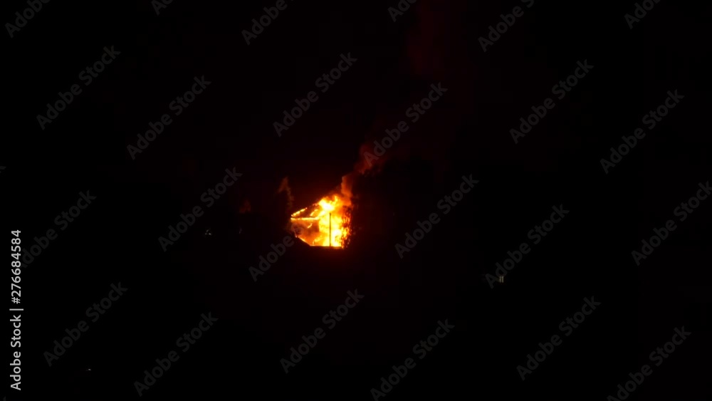 Apartment Building on Fire at Night Time. Burning Fire Flame with Smoke on the Apartment House Roof. Arson or Natural Disaster Concept Apartment Building on Fire at Night Time. Burning Fire Flame with Smoke on the Apartment House Roof. Arson or Natural Disaster Concept
