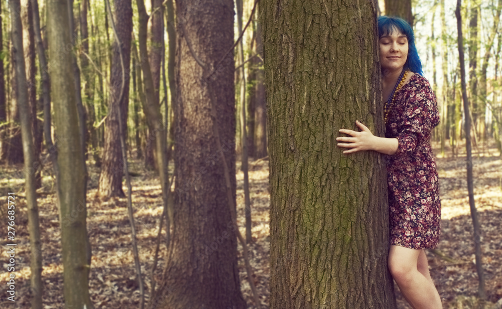 Portrait of a woman with an interesting appearance hugs a tree Portrait of a woman with an interesting appearance hugs a tree
