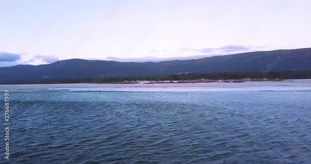 Sunset at a stunning Galician beach with a river estuary and a forest nearby n12