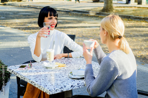 happy friends girls spend time in cafe. gossip concept. happy lunch. coffee time. free time with joy. bisiness meeting. summer cafe terrace. female frienship. Relax with coffee. Peaceful morning photo