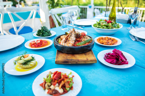 Shrimp  Seafoods  appetizers and salads on the table in Fish Restaurant. Beach Restaurant in Greece or Turkey. Aegean seaside  Greek or Turkish style fish restaurant in Bodrum  Santorini or Mykonos