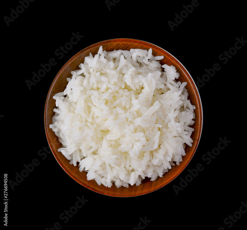 rice in wood bowl on black background
