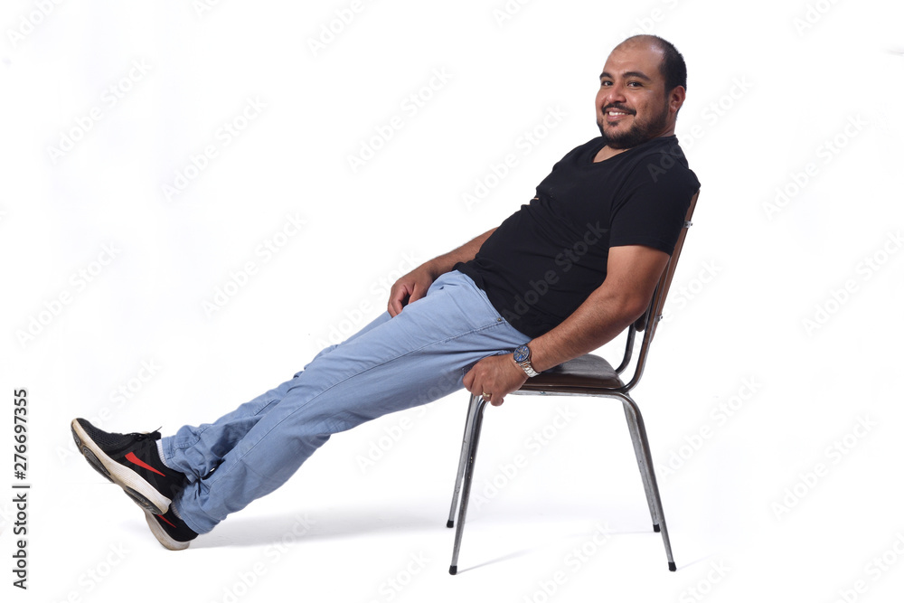 full portrait of a south american  man sitting on a chair on white