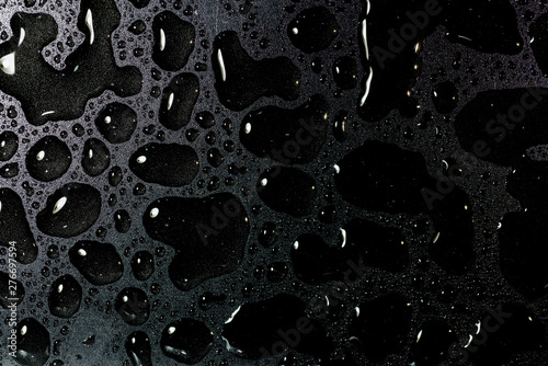 Top view liquid water droplets on a black background photo