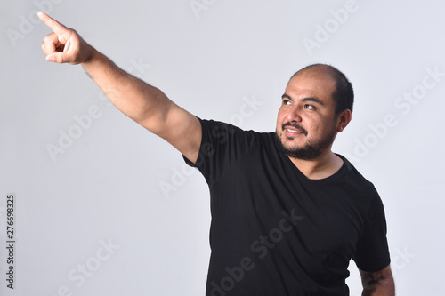 portrait of a latin american man  pointig on white background photo