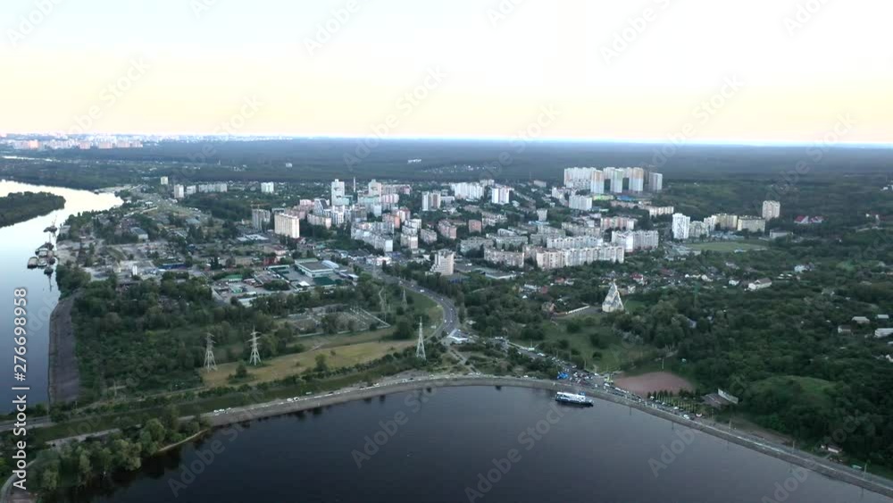 Aerial drone push-in shot of the Dnieper River coast of the city of Kiev, Ukraine during sunset Aerial drone push-in shot of the Dnieper River coast of the city of Kiev, Ukraine during sunset