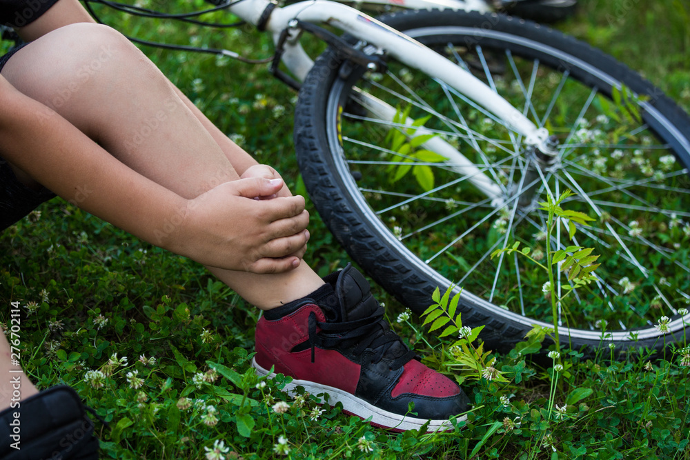 Concept bike accident, Young boy with pain in knee joints after biking