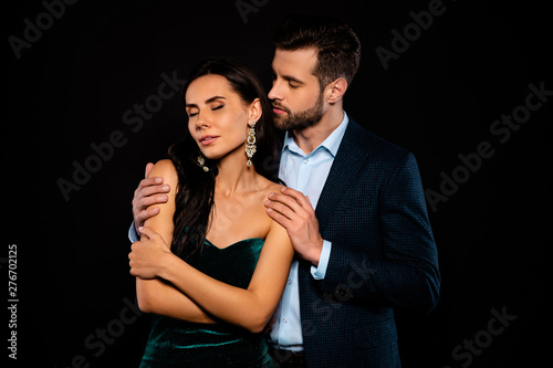 Close up photo rich pair classy she her chic eyes closed enjoy he him his hold touch shoulders tenderness piggyback pose wear blue plaid costume jacket velvet green dress isolated black background